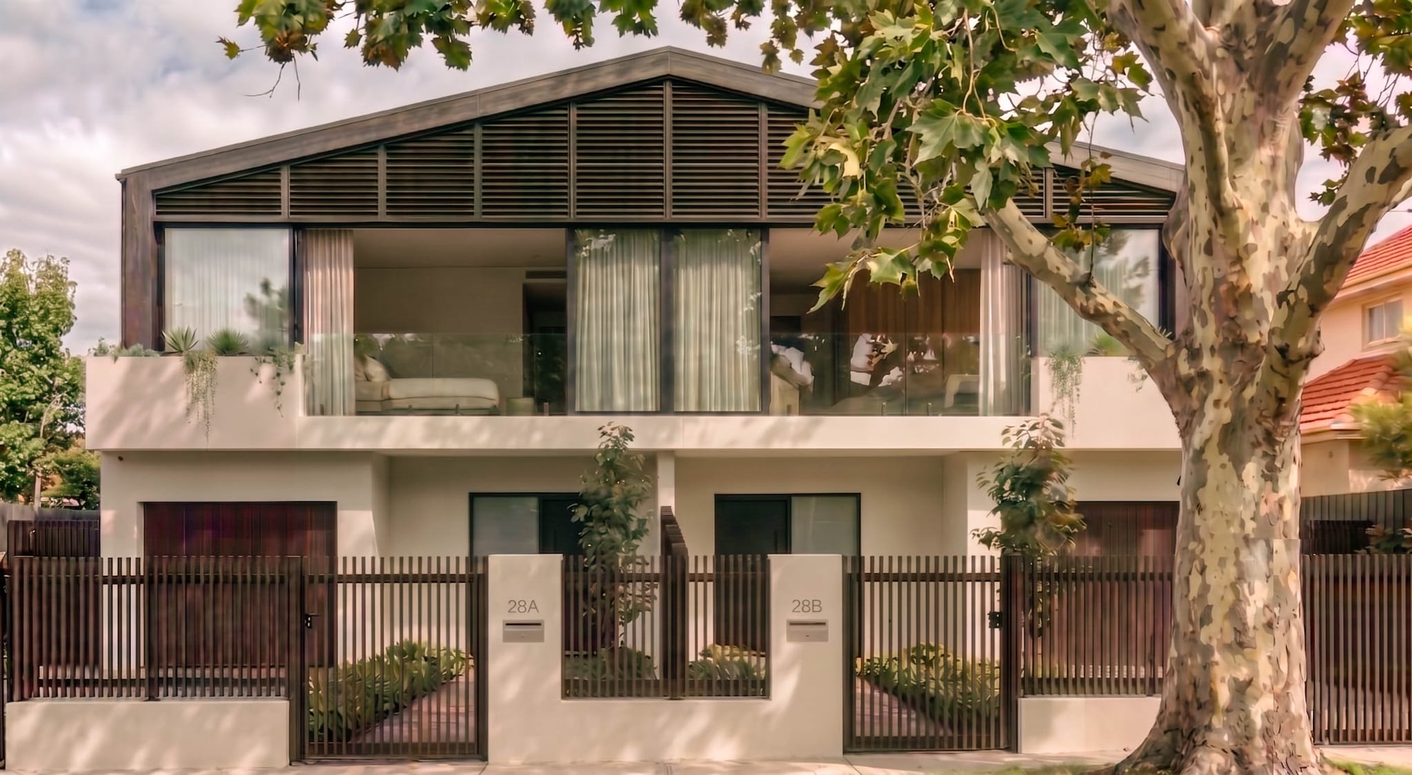 Duplex front elevation, Sydney: rendered masonry, a glazed upper level and louvred gable, dual occupancy by Aomura Studio